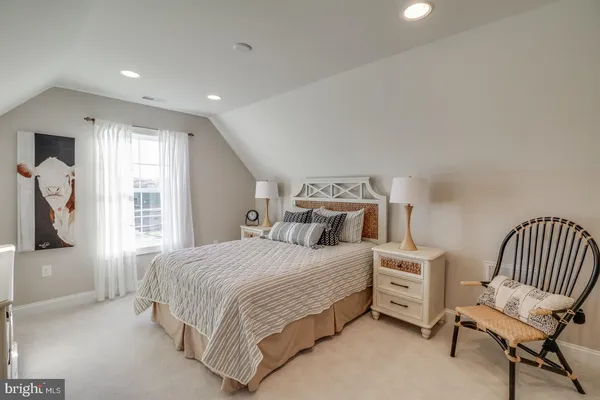 a bedroom with a large bed and a large window