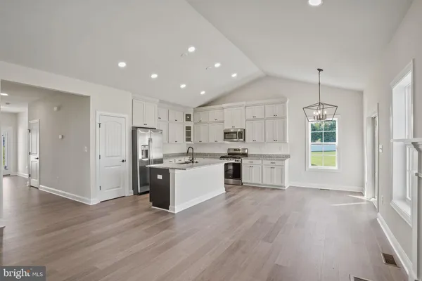 a kitchen with stainless steel appliances a refrigerator sink and cabinets