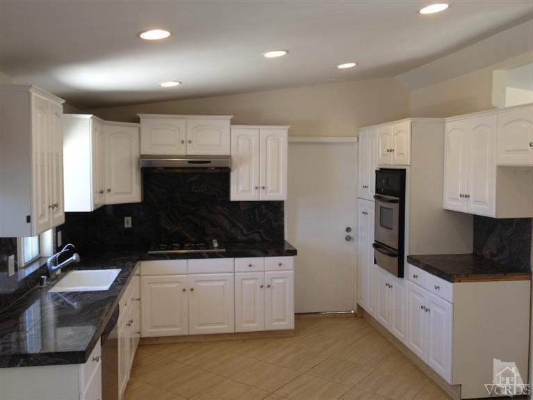 3230 Madera Place Oxnard, CA 93033 - Photo 2 of 9 a kitchen with a sink a stove and cabinets