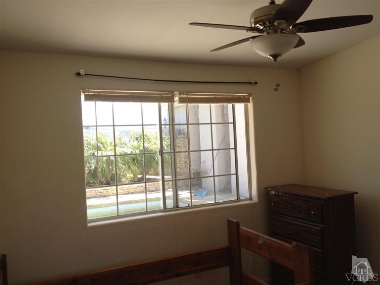 3230 Madera Place Oxnard, CA 93033 - Photo 6 of 9 a bathroom with a window and a ceiling fan