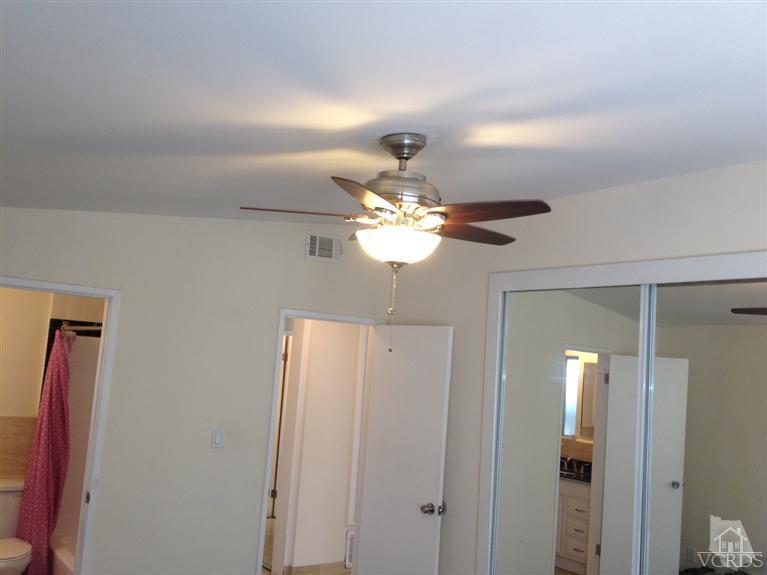 3230 Madera Place Oxnard, CA 93033 - Photo 7 of 9 a light fixture and a chandelier fan in a kitchen