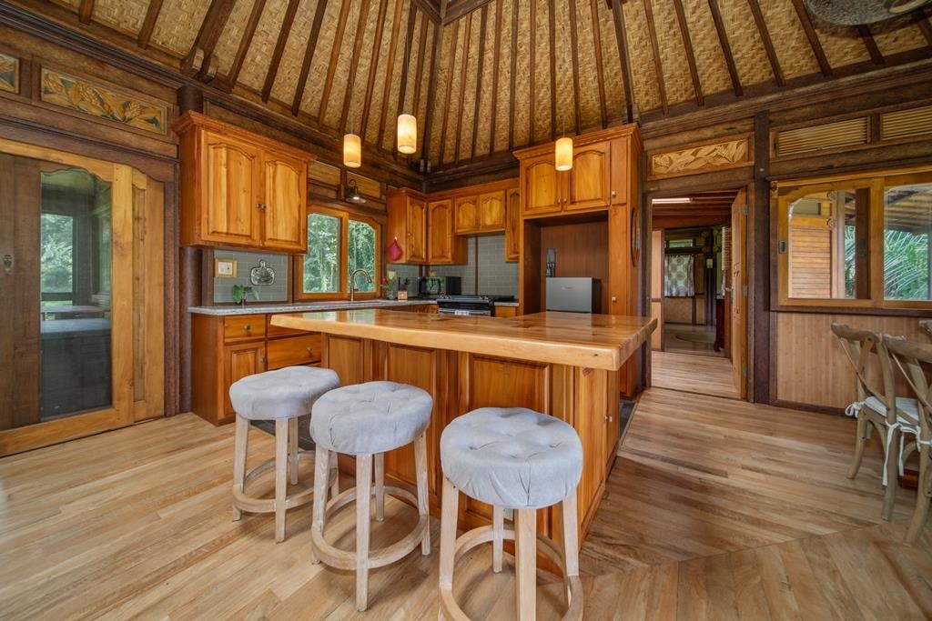 165 Waikoloa Road Hana, HI 96713 - Photo 15 of 50 a dining room with furniture and a chandelier