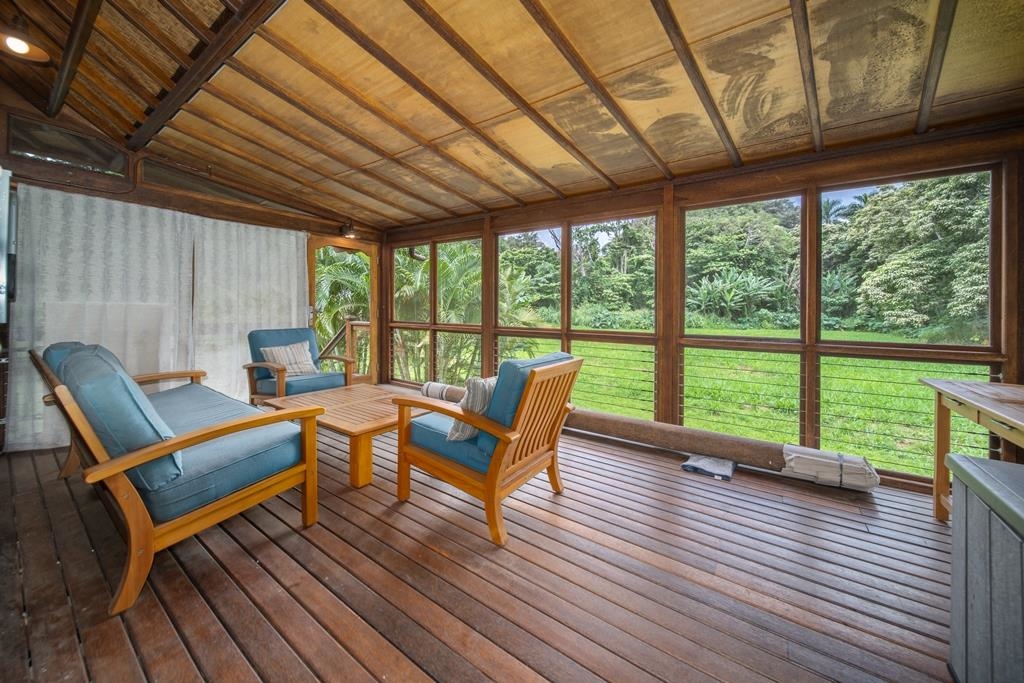 165 Waikoloa Road Hana, HI 96713 - Photo 25 of 50 a patio with lawn chairs and wooden floor