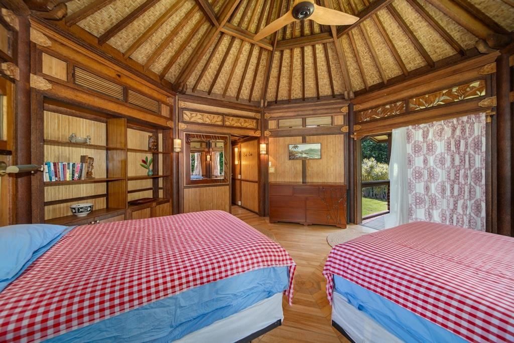 165 Waikoloa Road Hana, HI 96713 - Photo 30 of 50 a bed sitting in a bedroom next to a window