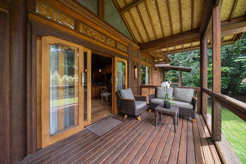 165 Waikoloa Road Hana, HI 96713 - Photo 32 of 50 a view of a patio with chairs and wooden floor
