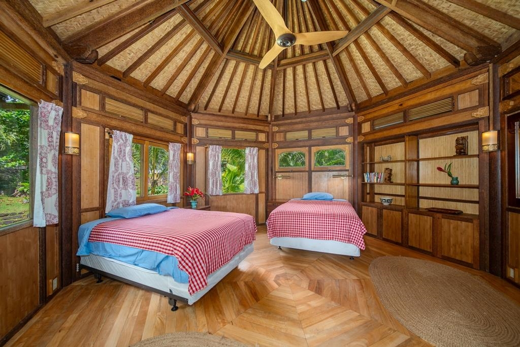 165 Waikoloa Road Hana, HI 96713 - Photo 37 of 50 a bedroom with a bed and large window