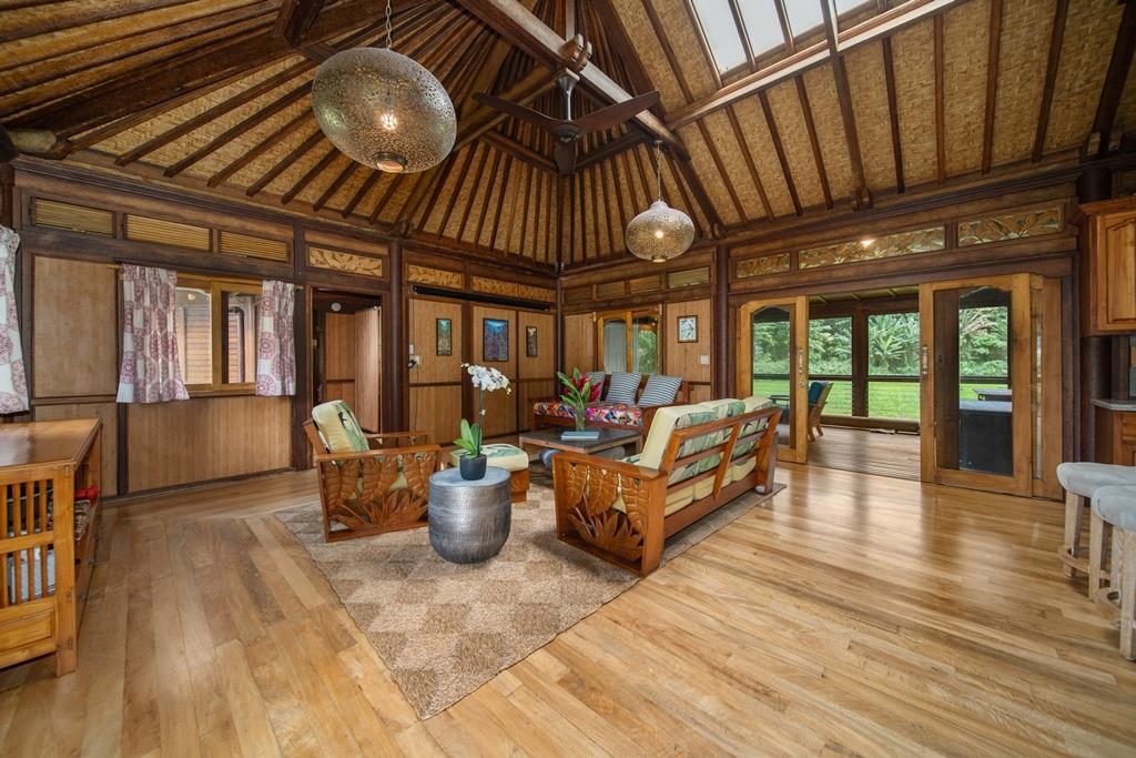 165 Waikoloa Road Hana, HI 96713 - Photo 9 of 50 a living room with furniture a wooden floor and next to a window