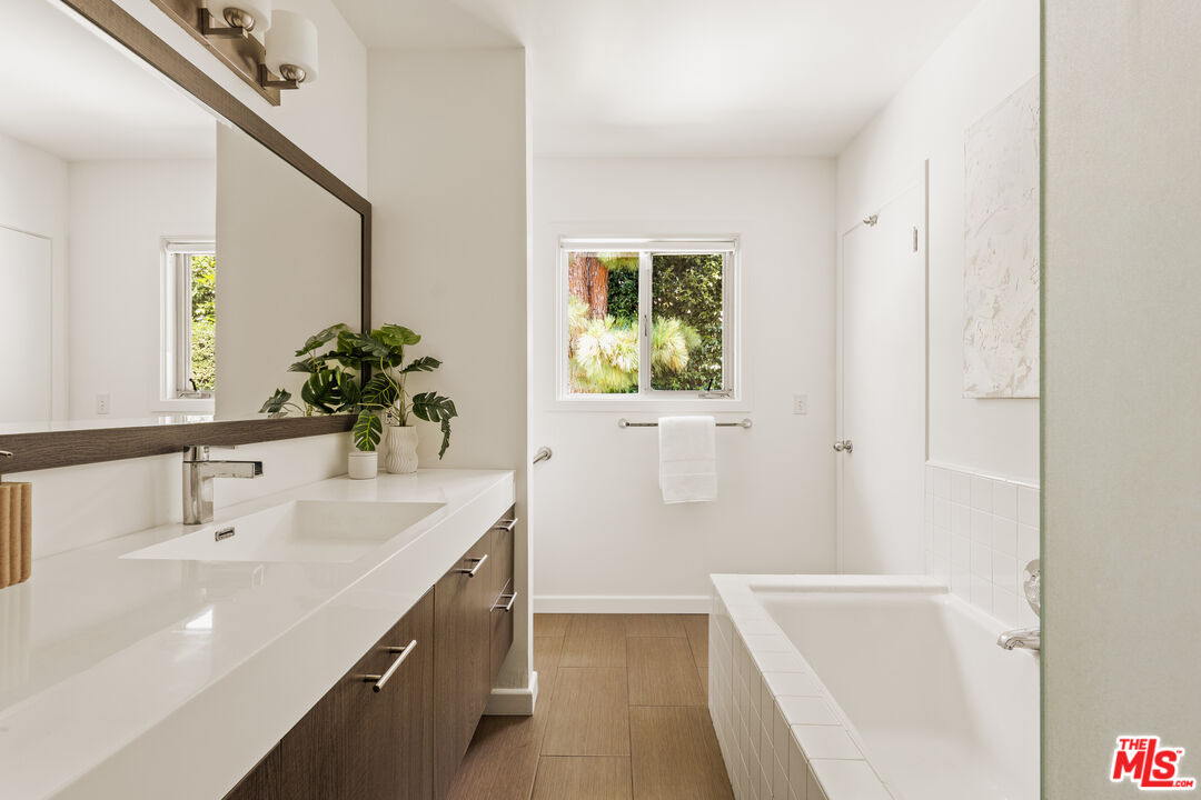 10749 Molony Road Culver City, CA 90230 - Photo 15 of 19 a bathroom with a sink a bathtub and a mirror
