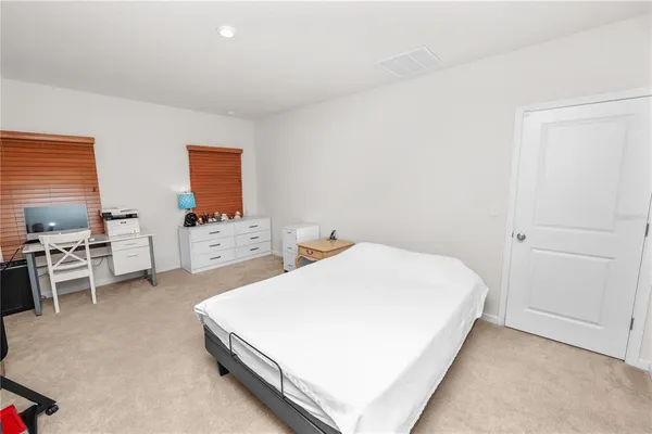 a bedroom with a bed and a cabinets