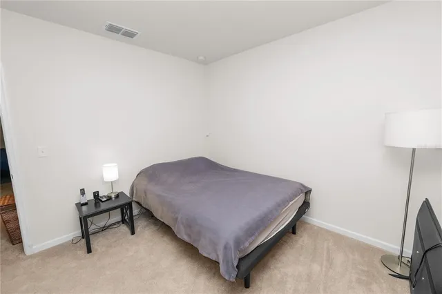 a bedroom with a bed and a table in it