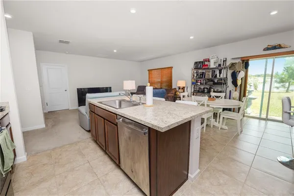 a kitchen with a stove a sink a microwave and a dining table