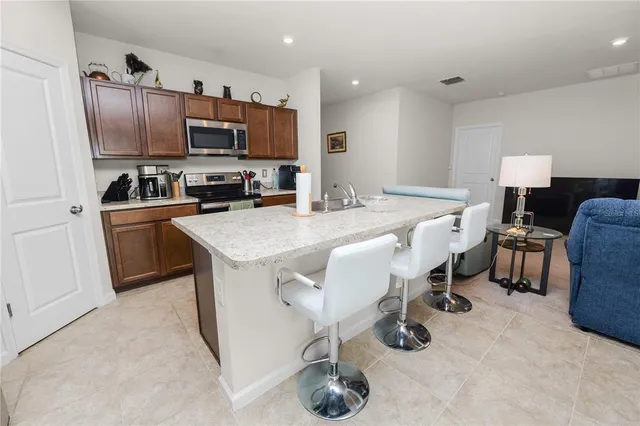 a kitchen with granite countertop a sink appliances and cabinets