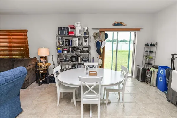 a dining room with furniture and a window