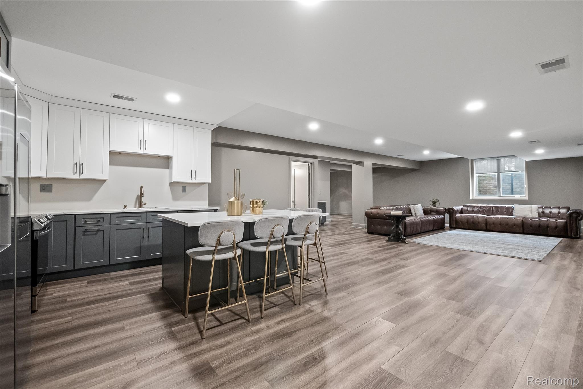 3824 Poppleton Street Troy, MI 48084 - Photo 51 of 51 Kitchen with two tone color scheme, a kitchen bar, a kitchen island, open floor plan, and dark wood finished floors