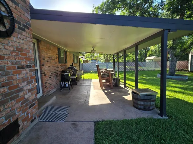 a view of a swimming pool with lawn chairs and a floor to ceiling window