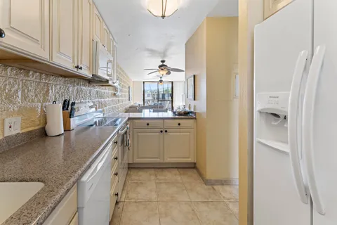 a kitchen with a sink cabinets and a window