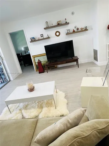a living room with furniture and flat screen tv