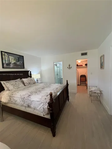 a bedroom with a bed and a table