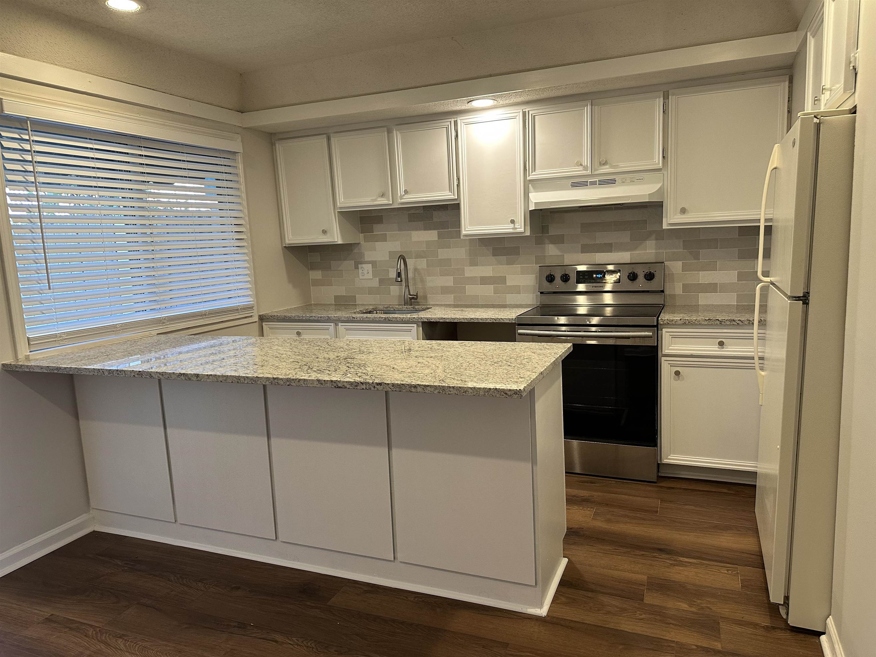 1214 Bristol Drive, Unit 1214 Memphis, TN 38119 - Photo 5 of 11 a kitchen with stainless steel appliances granite countertop a sink a stove a refrigerator and cabinets