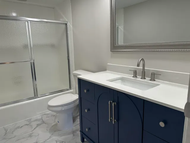 a bathroom with a sink toilet and shower