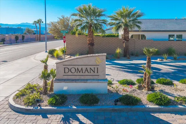 a view of a street with potted plants