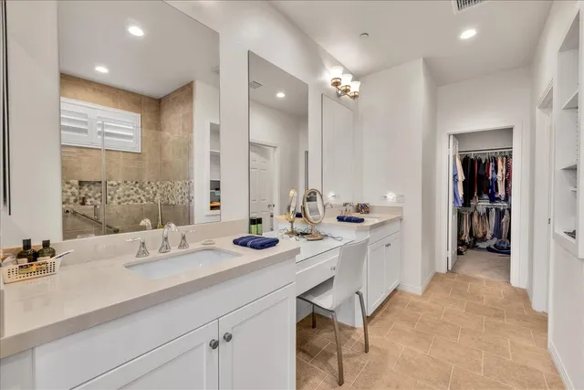 a bathroom with a sink double vanity and a mirror