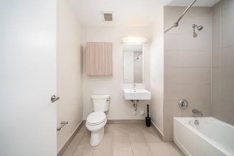 a bathroom with a toilet a sink and bathtub