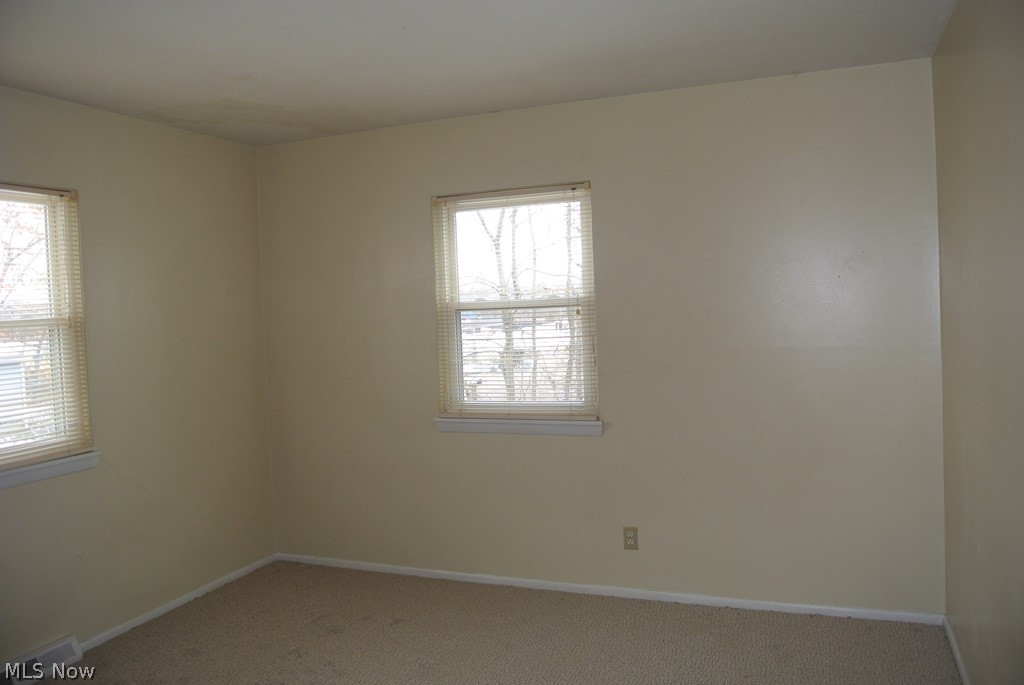939 Nevin Street Akron, OH 44310 - Photo 9 of 23 Unit B Carpeted empty room with plenty of natural light