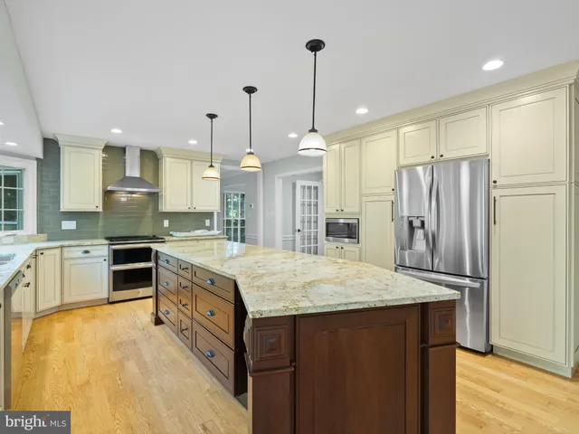 a kitchen with a stove a refrigerator and a sink