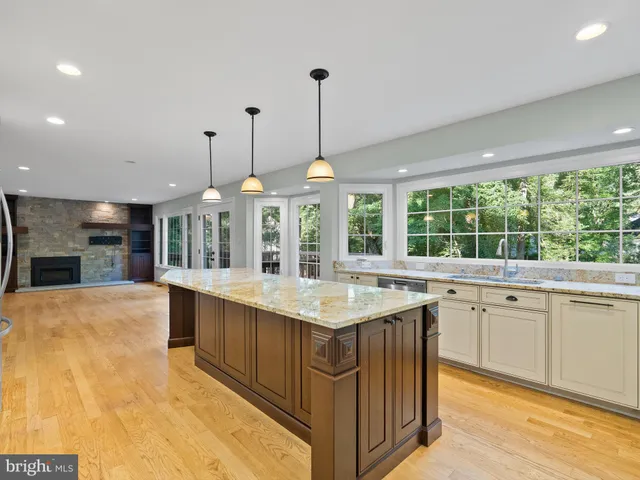 a kitchen with stainless steel appliances granite countertop a stove and a sink