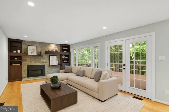 a view of an empty room with a fireplace and a window
