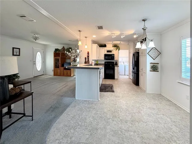a view of a kitchen and dining table chairs
