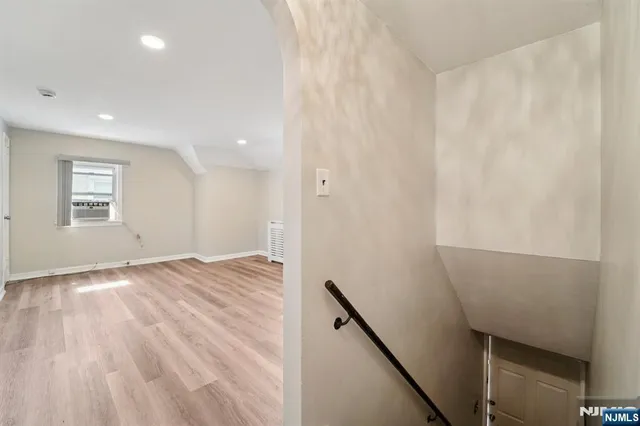 a view of a room with wooden floor and window
