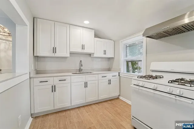 a kitchen with a stove a sink and a refrigerator