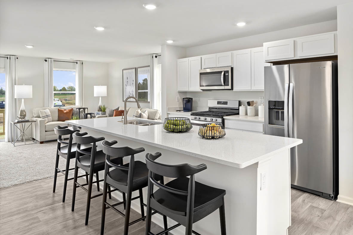2121 Sassafras Way, Unit E Wonder Lake, IL 60097 - Photo 4 of 51 a kitchen with stainless steel appliances a table chairs refrigerator and microwave