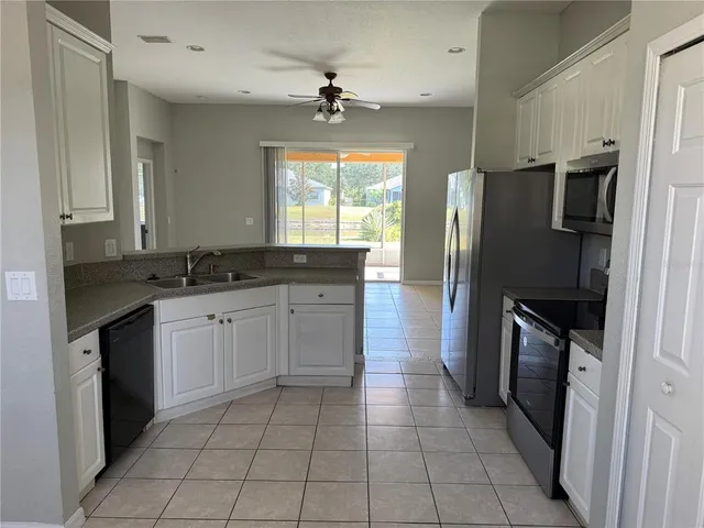 a kitchen with a refrigerator sink and stove