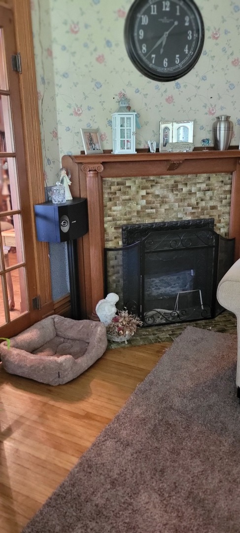 103 North Maple Street Momence, IL 60954 - Photo 35 of 43 a fireplace with a clock on top of it