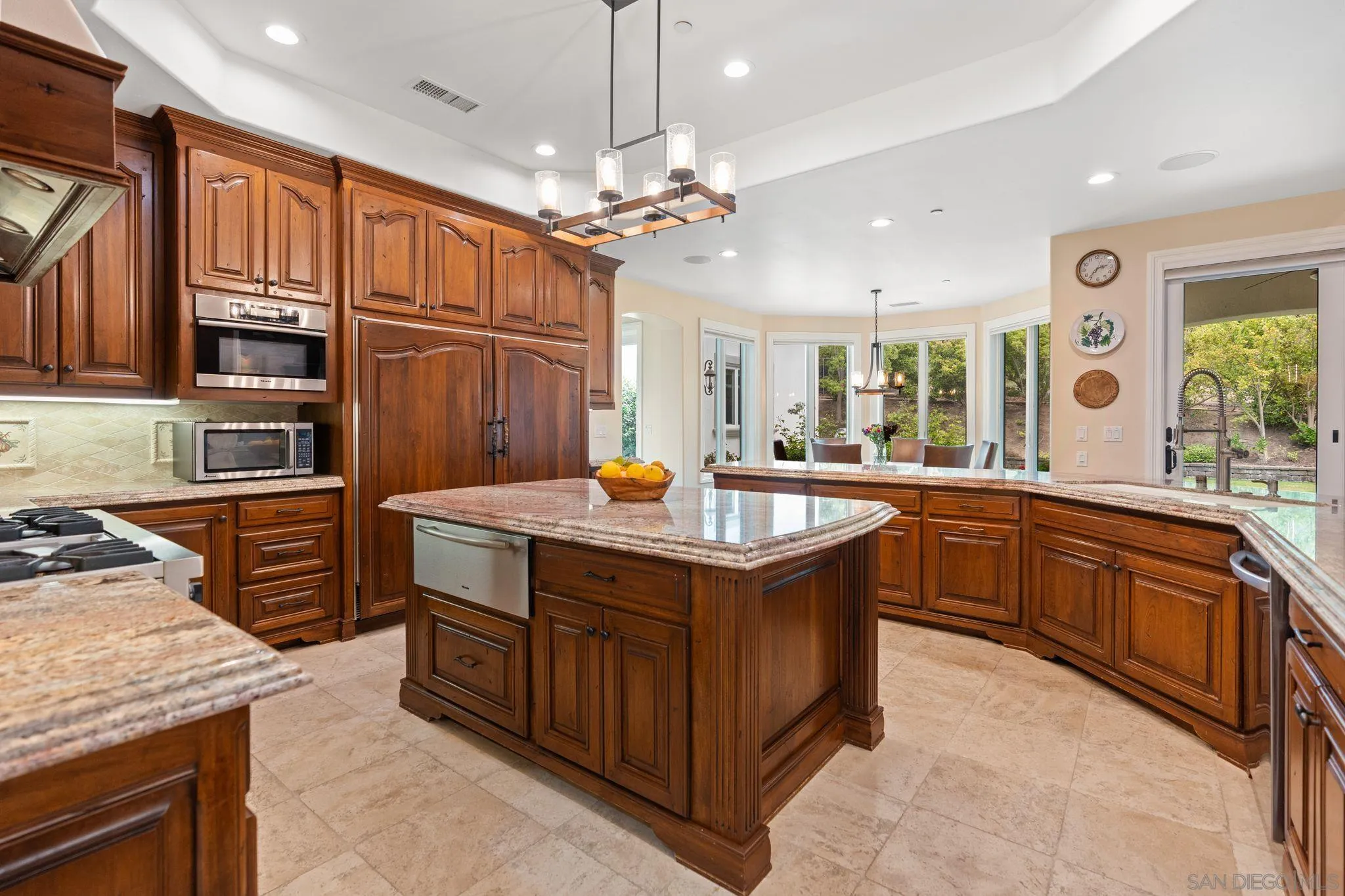 546 Morro Hills Road Fallbrook, CA 92028 - Photo 14 of 52 a kitchen with stainless steel appliances granite countertop a sink a stove and a wooden cabinets