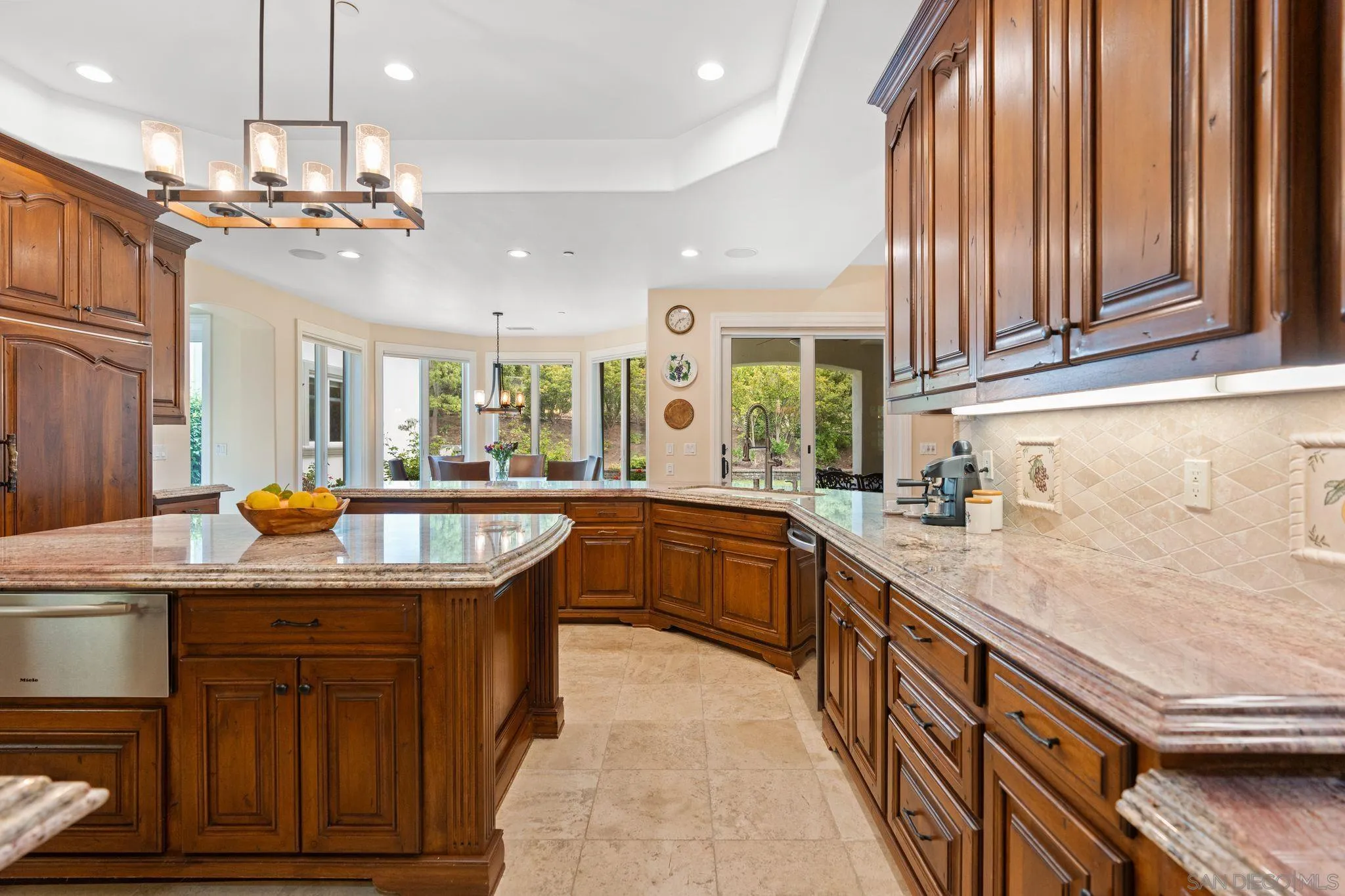 546 Morro Hills Road Fallbrook, CA 92028 - Photo 16 of 52 a kitchen with stainless steel appliances granite countertop a sink a counter space and a view of living room