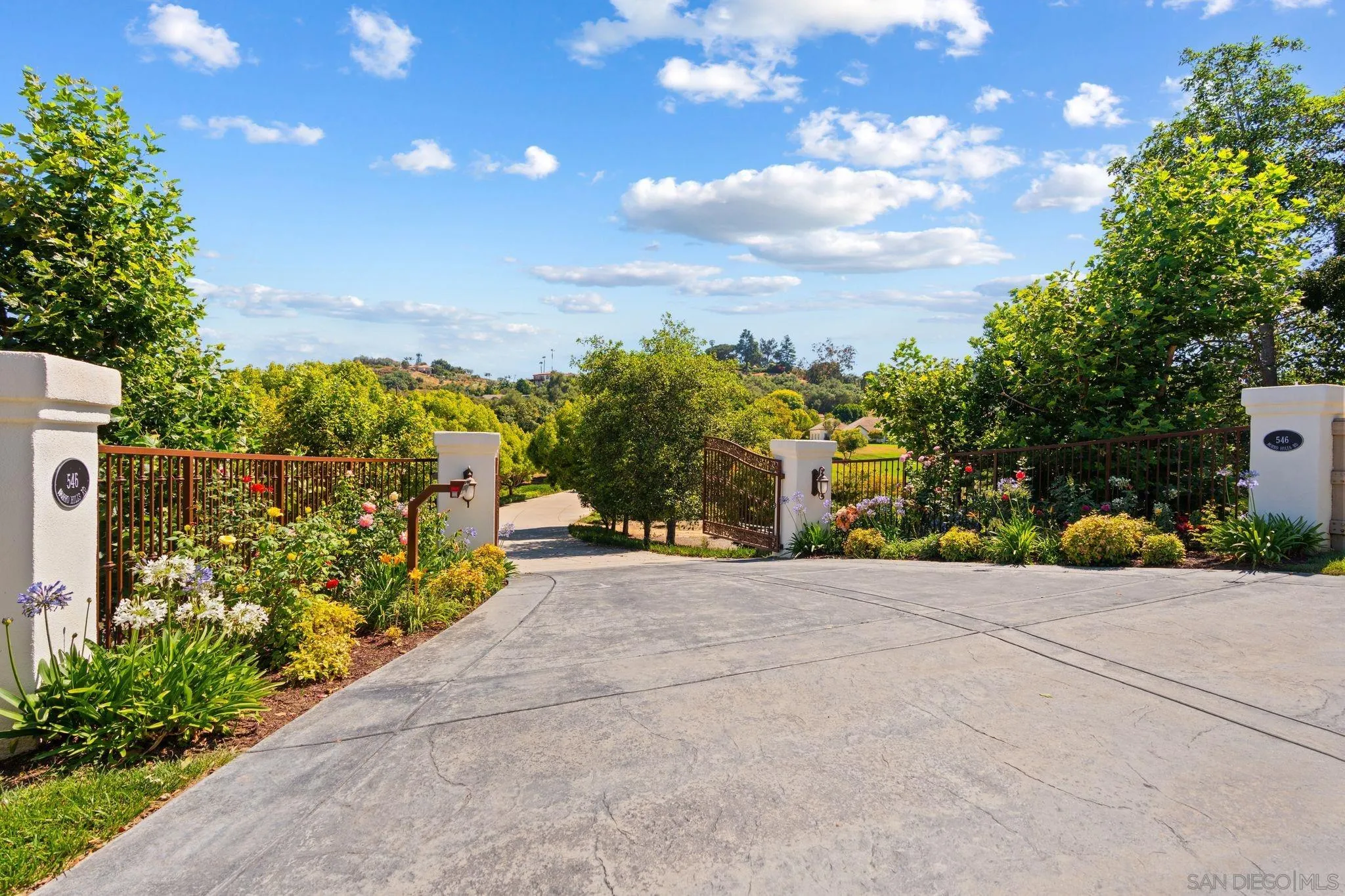 546 Morro Hills Road Fallbrook, CA 92028 - Photo 3 of 52 a view of a pathway with a wrought fence