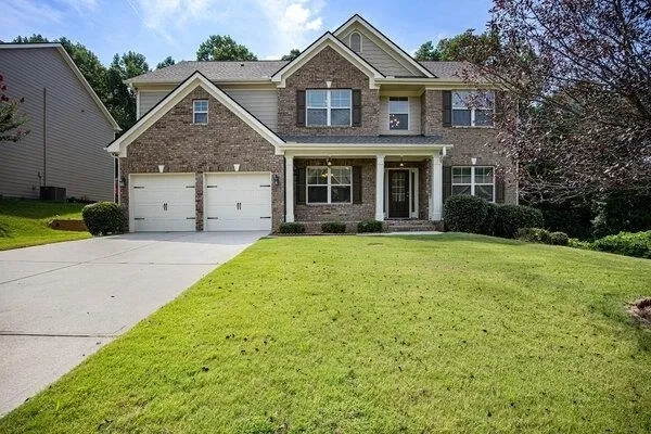 a front view of a house with garden