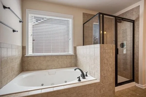 a bathroom with a bathtub and a shower