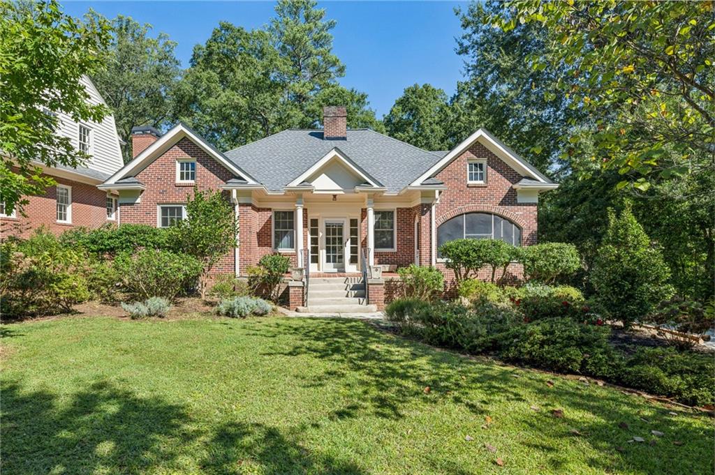 1460 Cornell Road Northeast Atlanta, GA 30306 - Photo 1 of 1 a front view of a house with a yard and trees