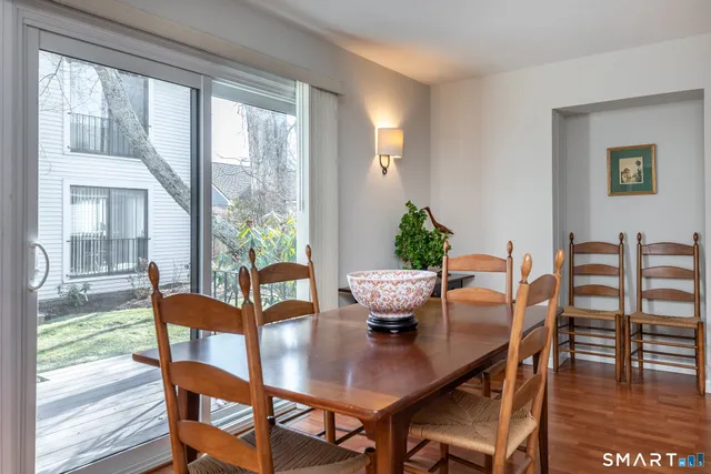 a view of a dining room with furniture window and wooden floor