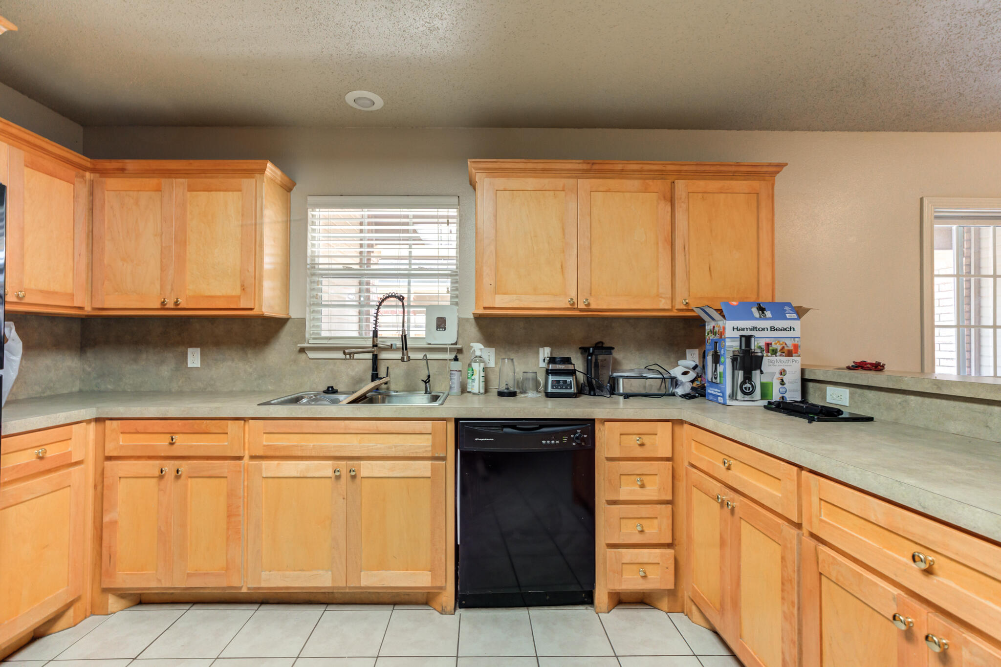 3114 109th Street Lubbock, TX 79423 - Photo 12 of 24 a kitchen with cabinets appliances a sink and a window