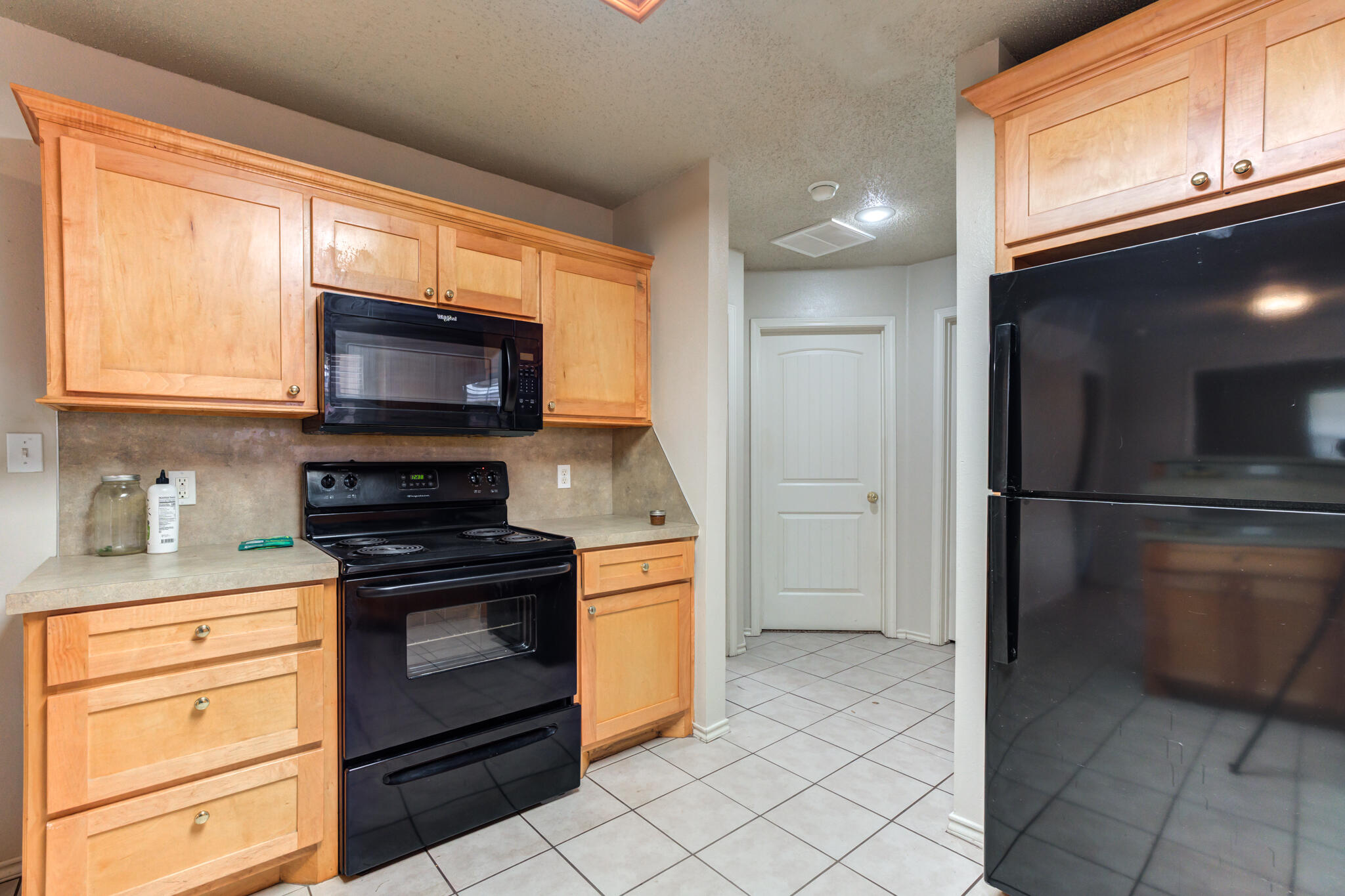 3114 109th Street Lubbock, TX 79423 - Photo 13 of 24 a kitchen with a refrigerator stove and microwave