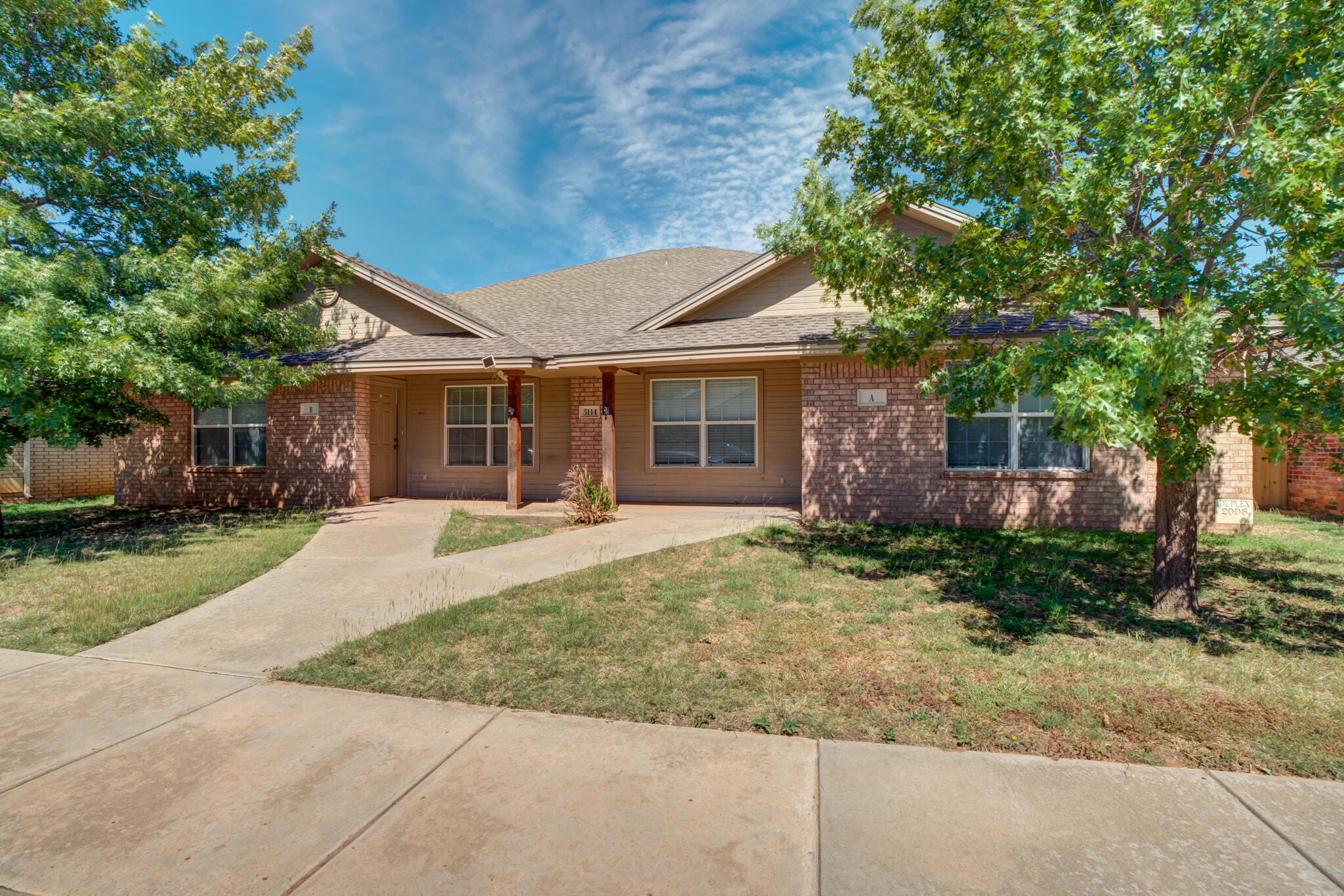 3114 109th Street Lubbock, TX 79423 - Photo 2 of 24 front view of a house with a yard