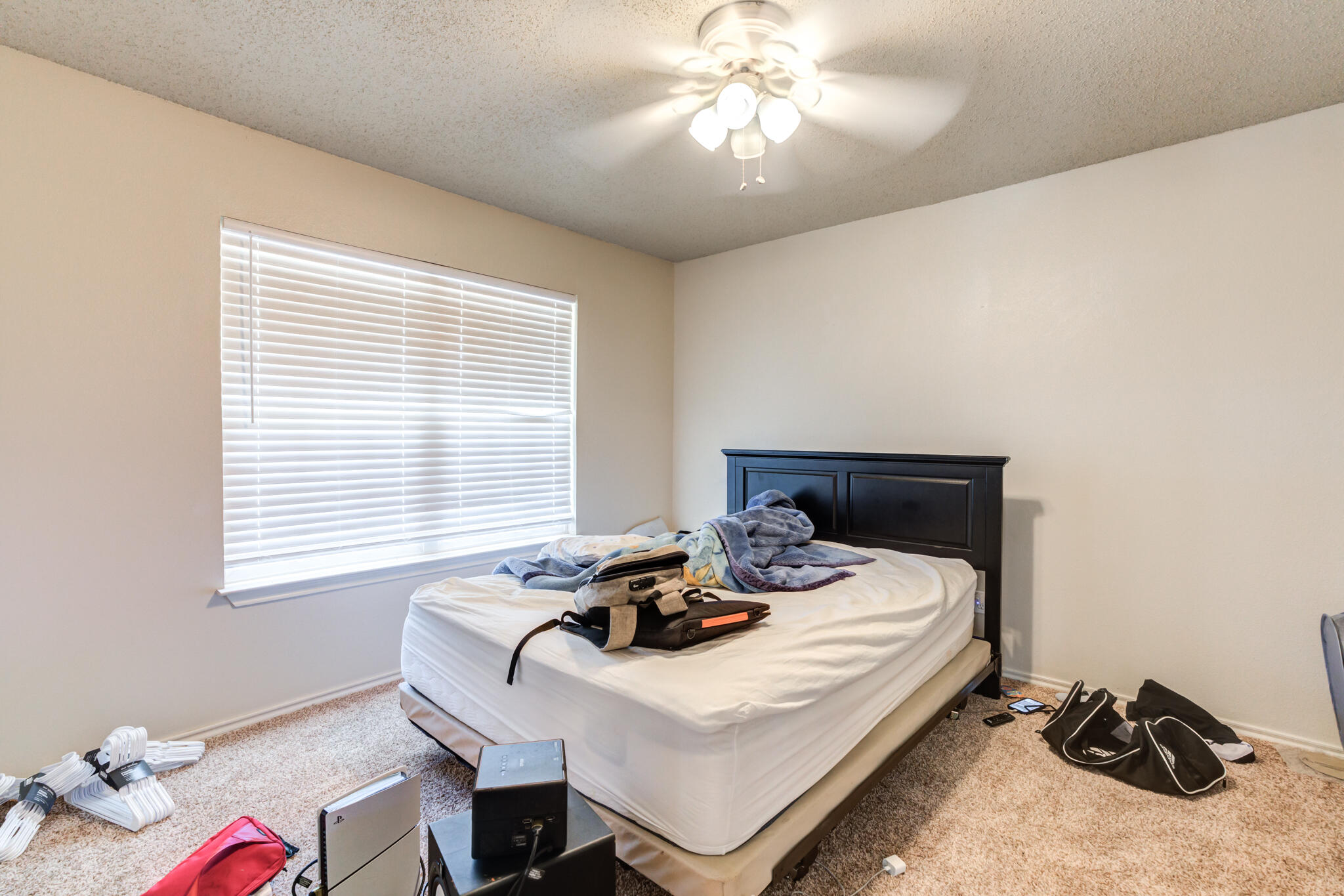 3114 109th Street Lubbock, TX 79423 - Photo 22 of 24 a white bed sitting in a bedroom next to a window