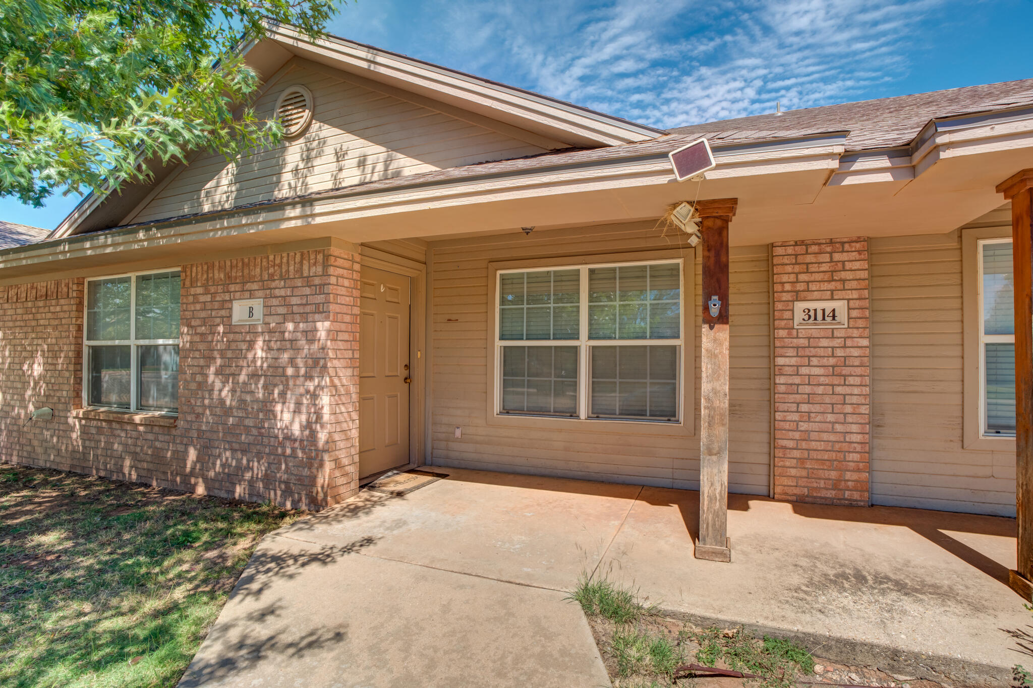 3114 109th Street Lubbock, TX 79423 - Photo 3 of 24 a front view of a house with a yard