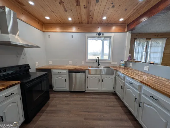 a kitchen with a sink stove and cabinets